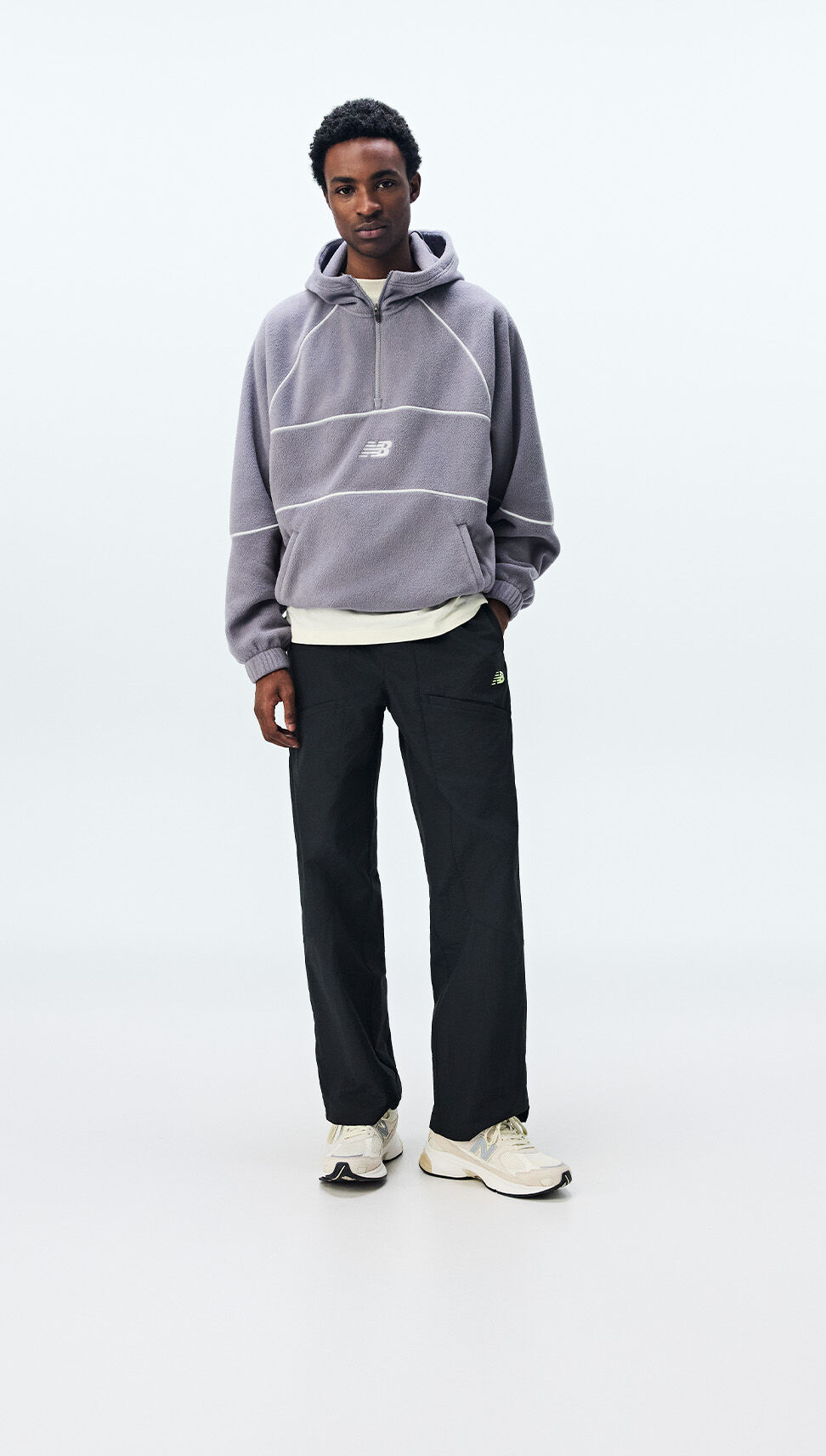 : A man wearing New Balance clothing on a white background
